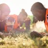 Sports, team and soccer group plank on field for fitness training, workout or exercise core outdoor.